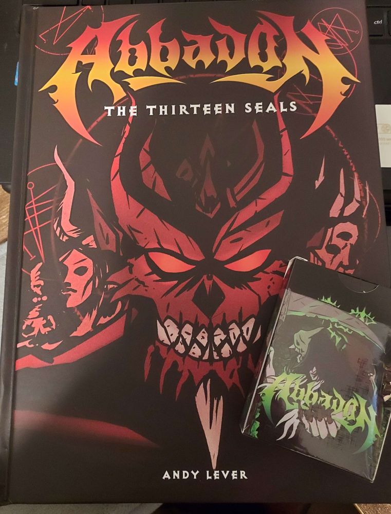 Physical copies of the Abbadon Core book and the matching Abbadon playing card deck.