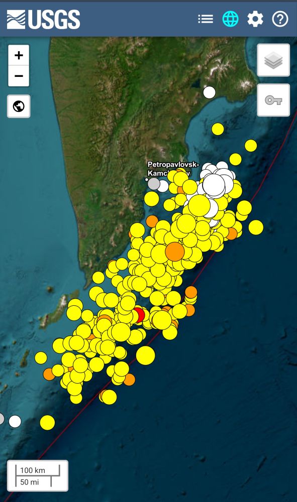 Map of the eastern coast of Russ near Kamchatka. There are a lot of white yellow, orange and red dots that mark the location of earthquakes.