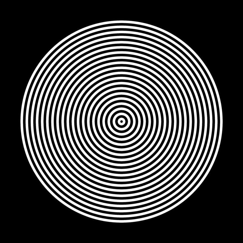 A black background with a white spiral design that radiates outward from a central point, creating a hypnotic and symmetrical pattern with evenly spaced concentric circles. *) Alt text generated by AI