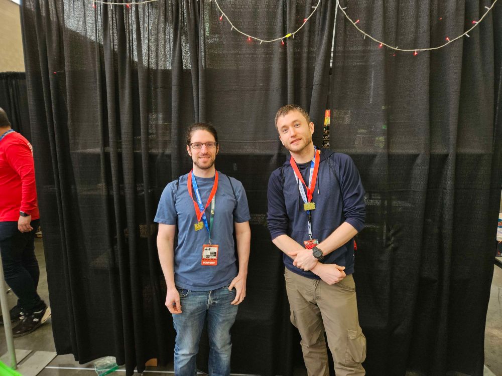 Winners of two Kingdomino tournaments at PAX East 2025, posing with medals 