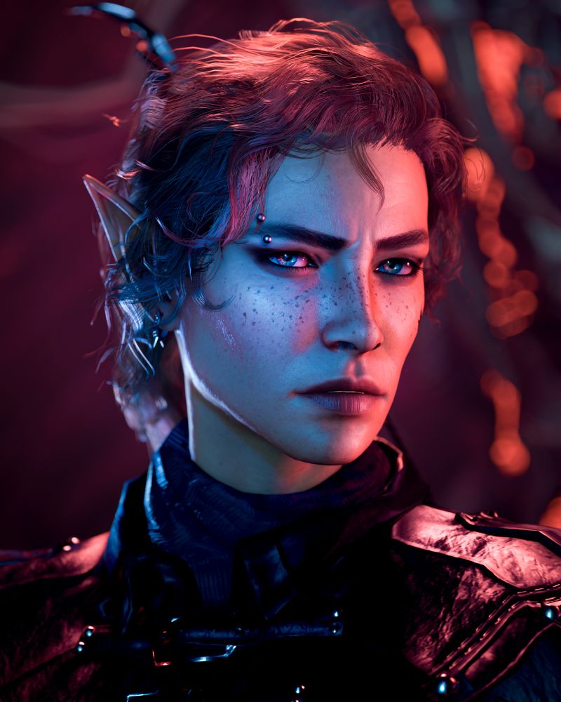 A screenshot of a half-elf gloomstalker ranger Tav from Baldur's Gate 3. Her face is bathed in red and blue light and she wears leather armour. She has red curly hair pulled back in a ponytail, green eyes, studded earrings and a piercing in her right eyebrow.