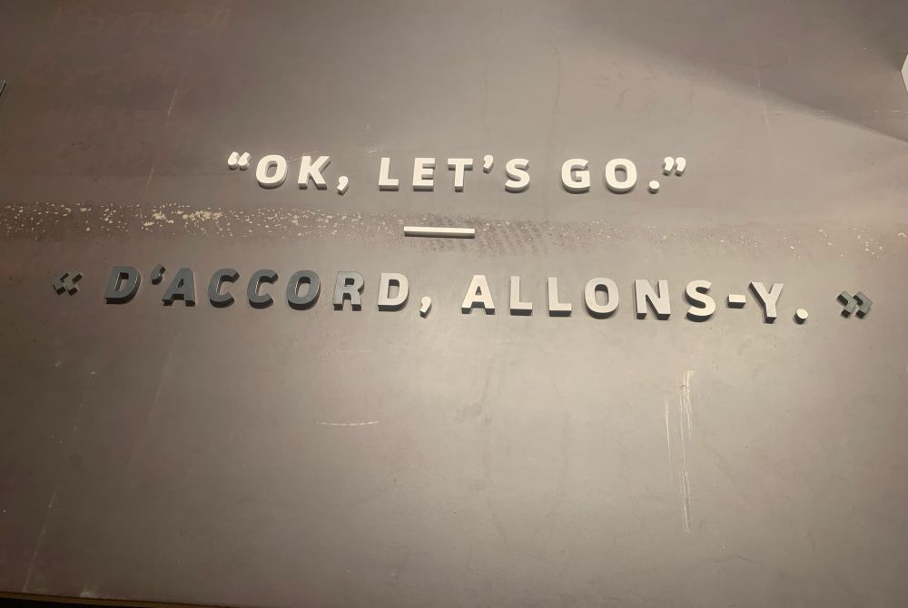 Brass plaque at the American Cemetary in Normandy, France. “Ok, Let’s go.” “D’accord, allons-y.”