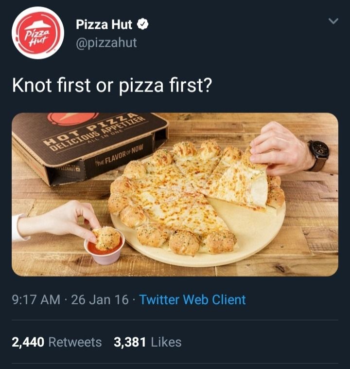 A screenshot of a tweet from @pizzahut. The tweet features a picture of a cheese pizza with garlic knots for the crust, and is captioned, "Knot first or pizza first?" 