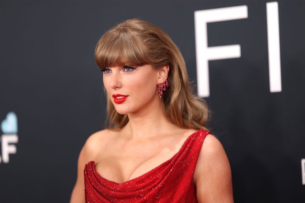 close up of taylor swift in red short sparkly dress at 2025 grammys 