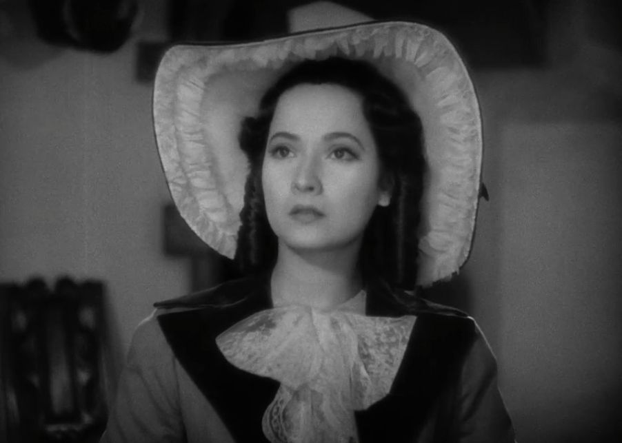 Merle Oberon wearing a massive hat in Wuthering Heights.