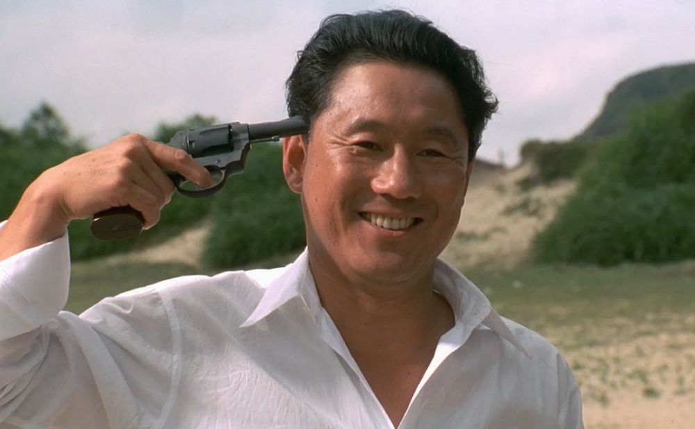 Man holding a pistol to his head.