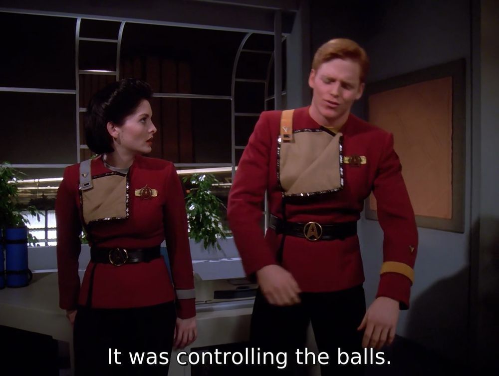 TNG; "Tapestry"; Picard's friends Marta and Corey in monster maroon; Corey appears to be walking funny with his legs in a wide stance and arms hanging at his sides, with caption: It was controlling the balls.