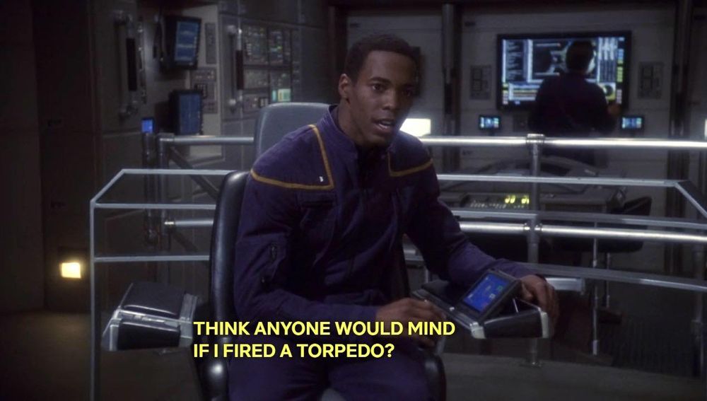 ENT; "Cold Front"; Travis Mayweather sitting in the captain's chair of the Enterprise NX-01, with caption: Think anyone would mind if I fired a torpedo?