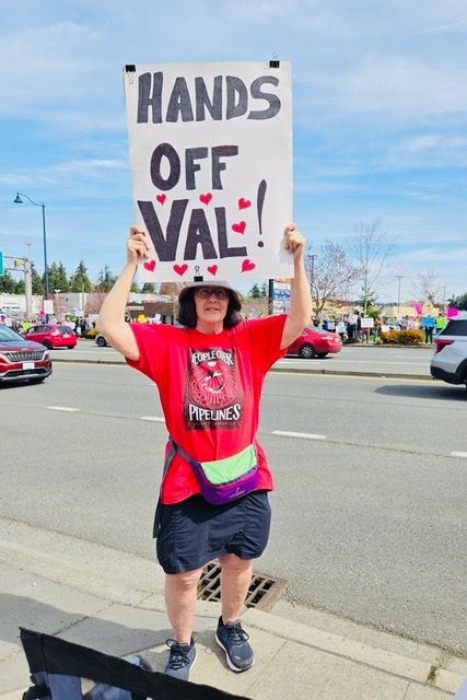 Friend holding "Hands Off Val" sign she made