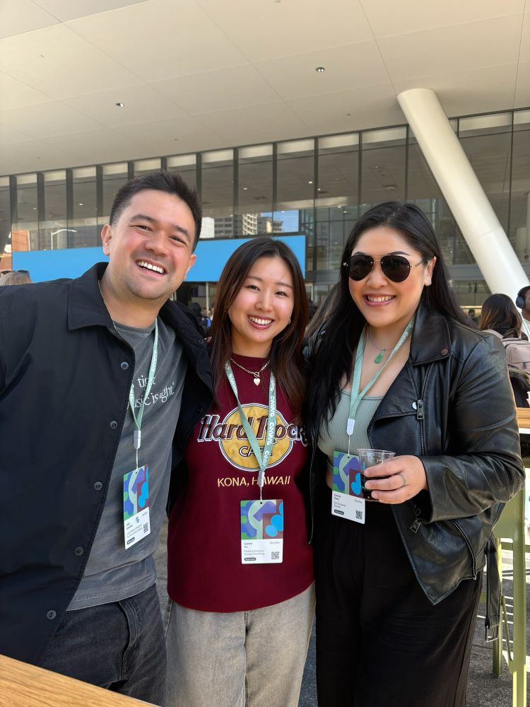 Photo of a man and two women standing outside of Moscone Center