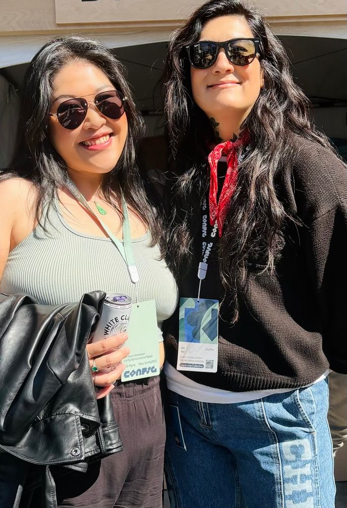 Photo of two women with the sun beaming on them because we are fire but also both wearing sunglasses