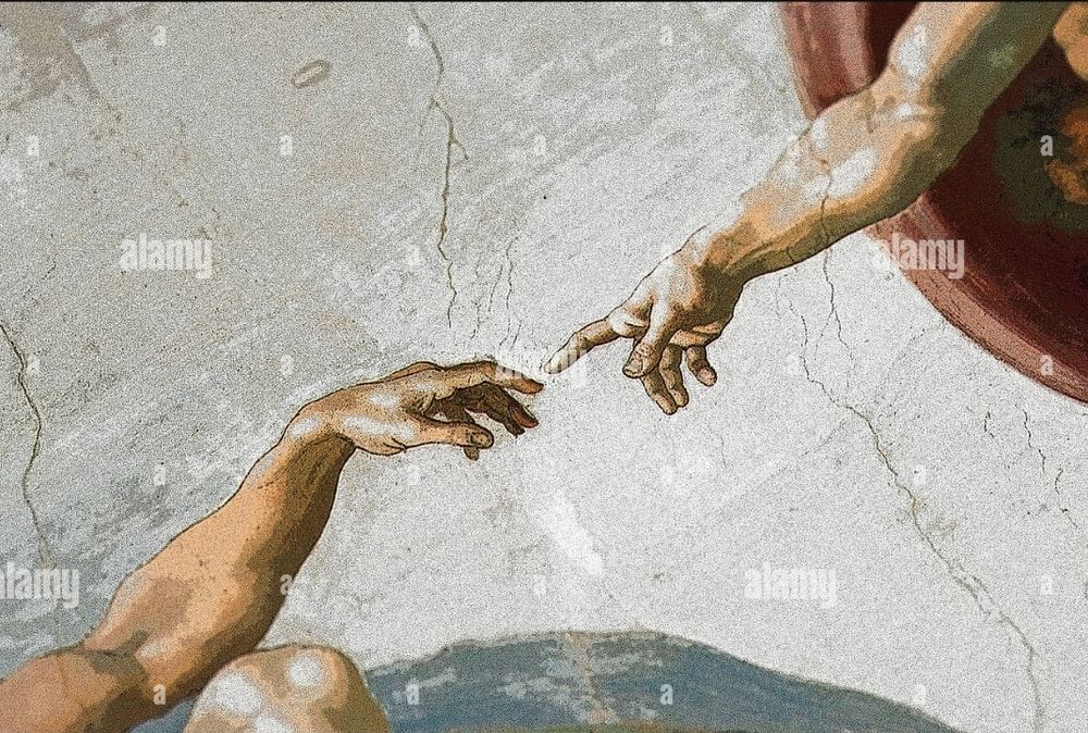 Two outstretched arms and hands nearly touch at the fingertips. The right hand belongs to a divine figure, the left to a naked man. The image is part of Michelangelo’s famous fresco in the Sistine Chapel, symbolizing the creation of Adam by God.

