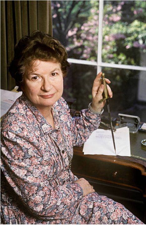 James at her writing desk. She puts a long dagger to the page.