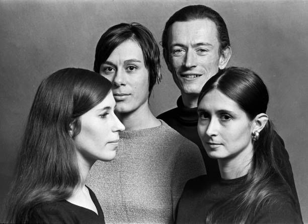 The four pose in a group for a black & white photo