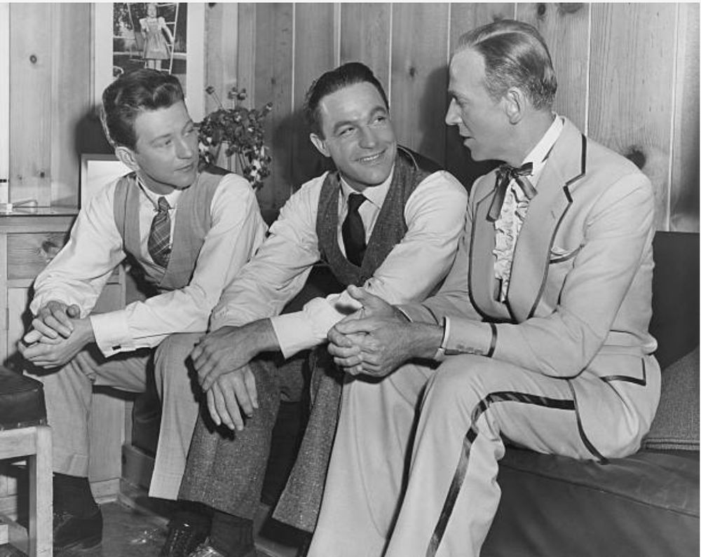 The three dancers talk shop on the set.