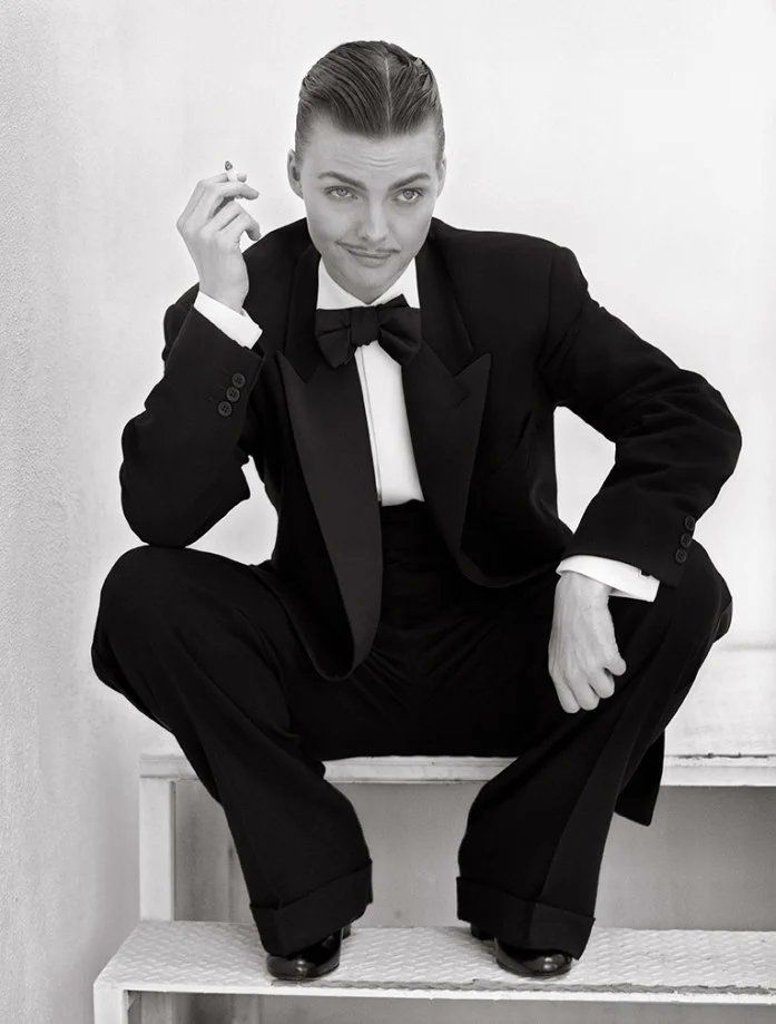 Pfeiffer in a man's tuxedo, smoking a cigarette