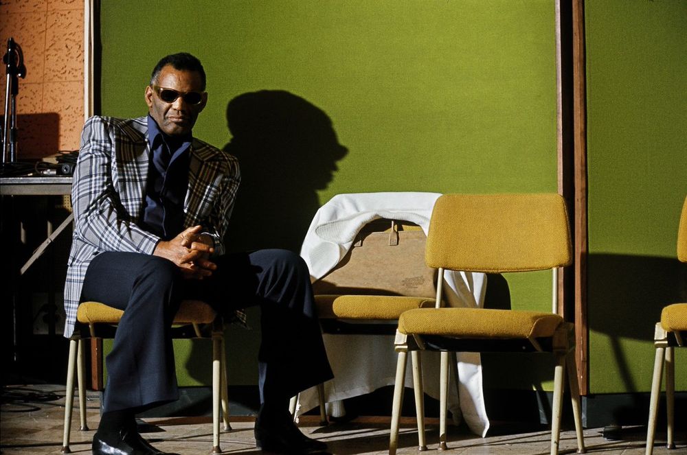 Charles sits in the studio, with wonderful light coming in from the side.