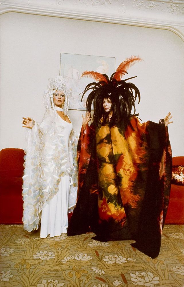 Two incredibly elaborate feathered costumes: Bardot in white & Fini in black, yellow & orange. Unidentified photographer.