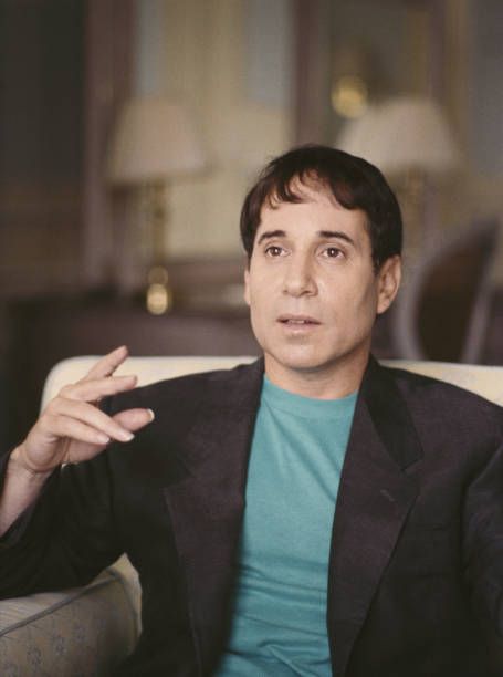 Simon in a blue t-shirt & sport coat.