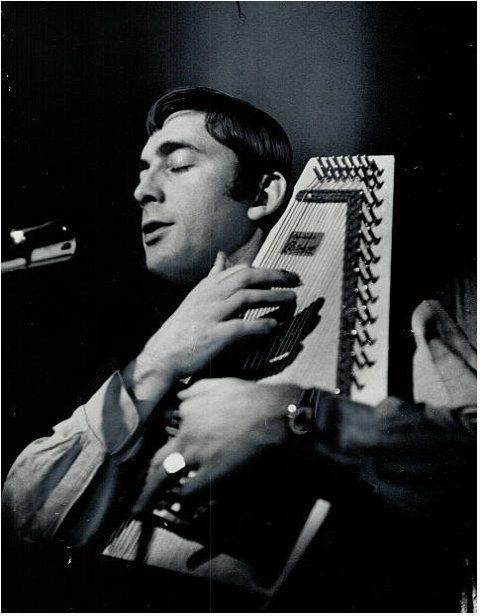 Tyson playing an autoharp & singing