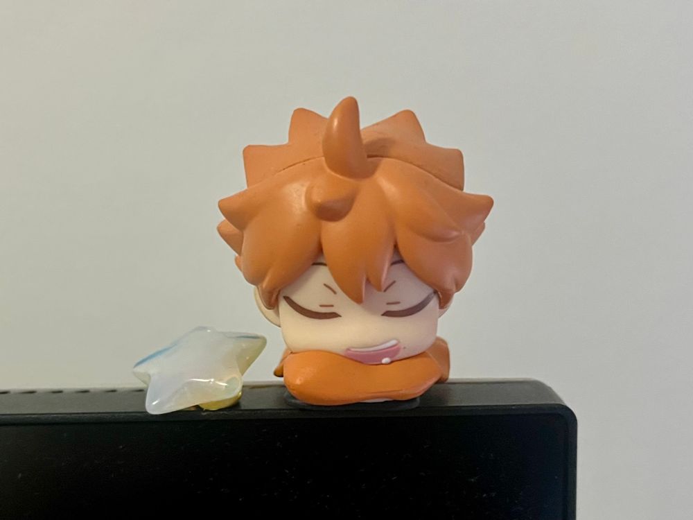 Shoyo Hinata from “Haikyu!!” asleep on his sleeping bag next to a star.