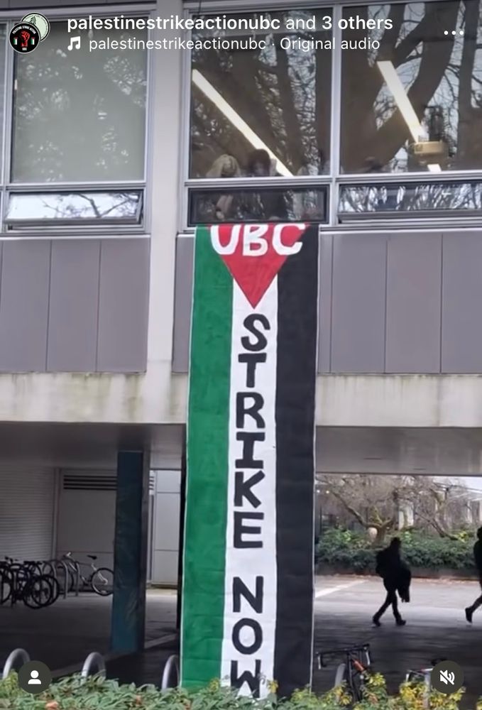 A banner in the colours of the Palestinian flag that says UBC STRIKE NOW unfurled by students outside the window of the Buchanan building at UBC Vancouver 