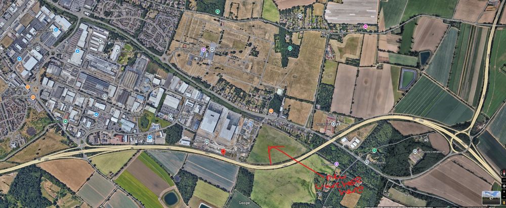 An areal view of the location mentioned in the article quoted by Jonn in his very good article. The quoted BBC article can be found here: https://www.bbc.co.uk/news/articles/c2kgvdgeq1yo . Jonn's is here: https://www.newstatesman.com/politics/uk-politics/2025/03/labours-halfway-there-planning-reforms . The run of houses affected in the BBC article is bordered to the west by a major junction of the A14 and to the east by a major conurbation - Ipswich. The warehouse seems to have been put in a sensible gap between the houses, the outskirts of Ipswich and the A14. An entirely sensible location, using the major A road as a boundary of the development. The "views" of the people in the house through the treasured southward aspect were of a busy trainline, a small field and the major A road (which is a dual carriageway). There are more fields further south after the A road, but these people are not living in a 'semi rural location', they are living on the edge of a field which was obviously destined to be bult on as a continuation of the Ipswich conurbation and which clearly has excellent access to a major A road for distribution. A very sensible place for a warehouse. Don't buy houses on the edge of developments or towns and expect your view of a field to be uninterrupted forevermore guys. 