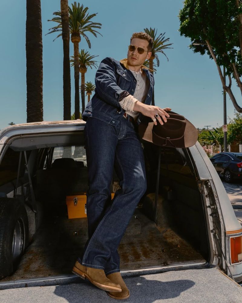 Oliver Stark posing seductively on the back of a truck with a cowboy looking hat waiting for the day I’ll be ably to ride him with the hat on - hold on baby it won’t be long 
