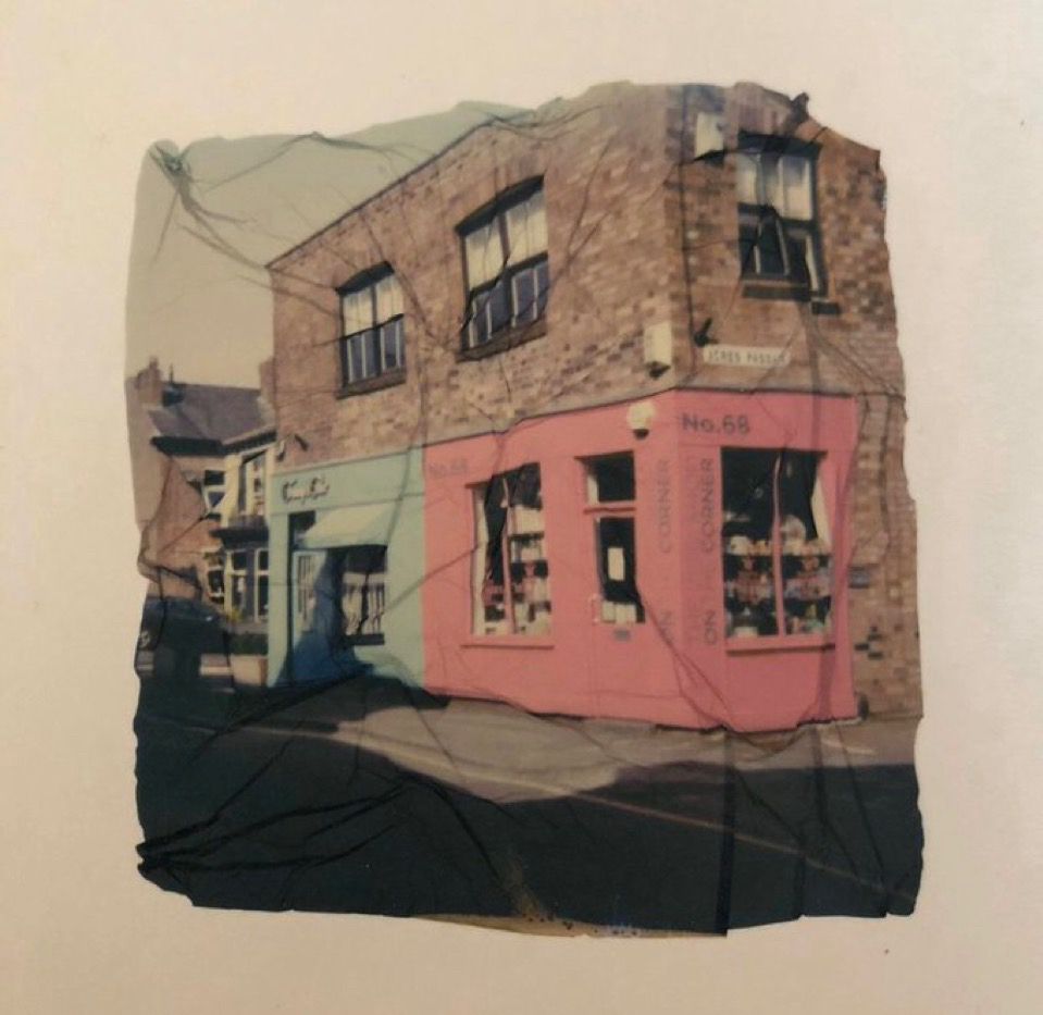 Polaroid lift of a blue and pink shops
