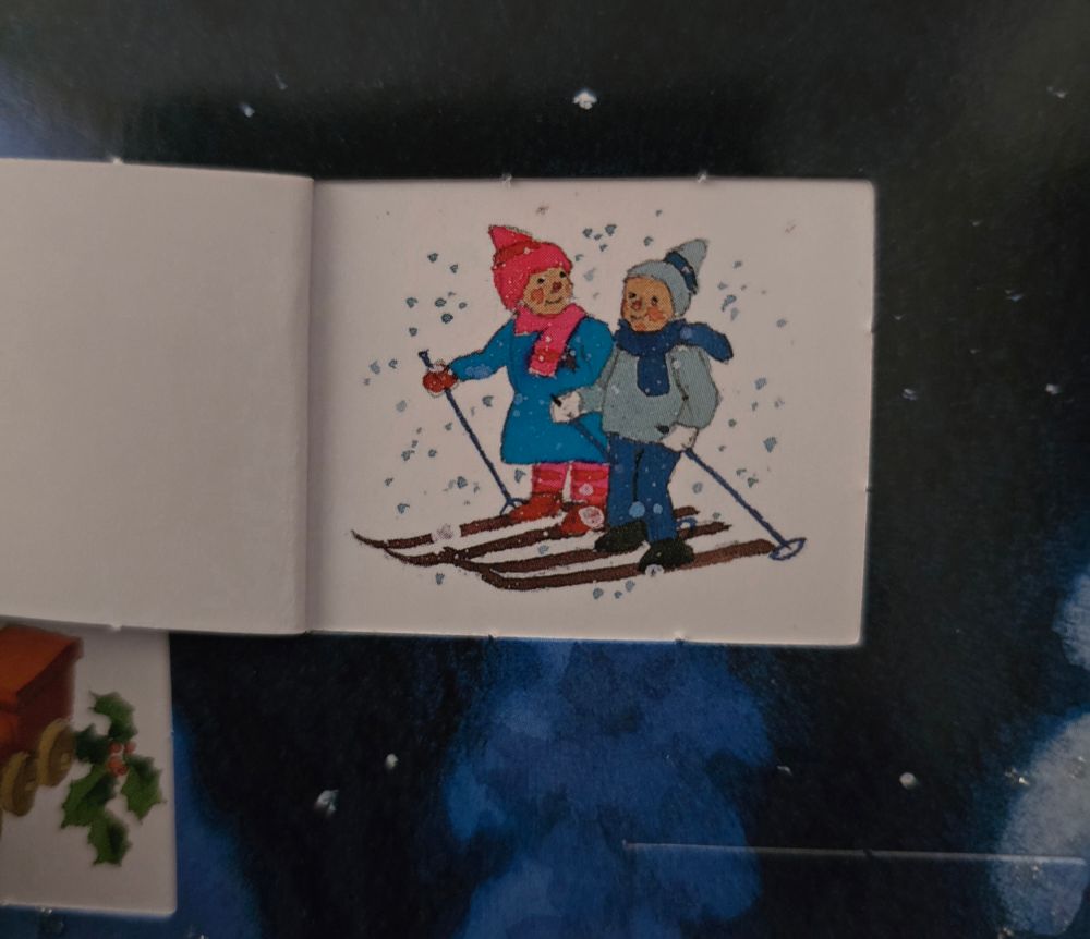 An image from an advent calendar showing two children skiing.