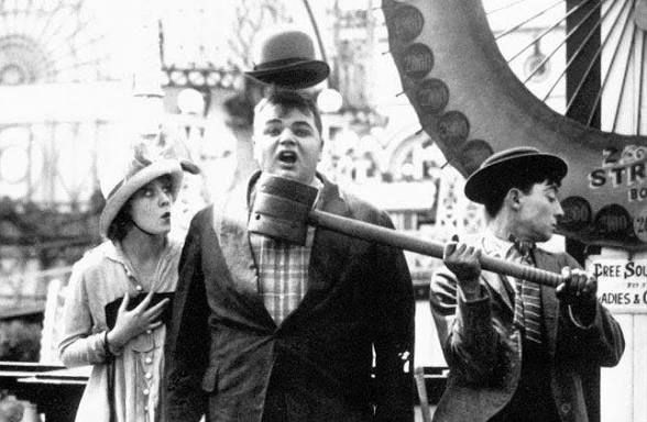 Roscoe Arbuckle getting hit by Buster Keaton in the slapstick comedy short film 1916’s Coney Island.