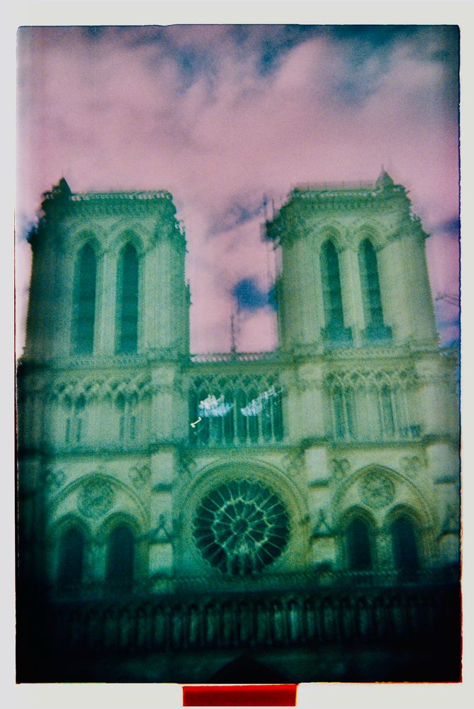 Blurry photo of notre dame with spooky colors and ghostly lighting