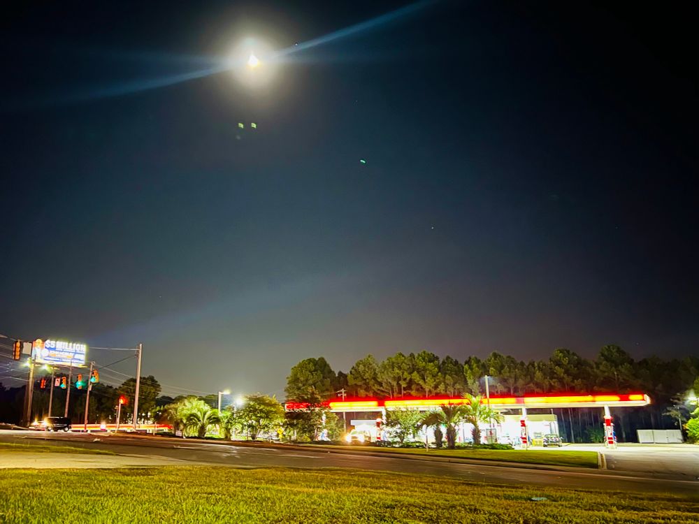 the full moon over a couple of gas stations in columbia south carolina 
