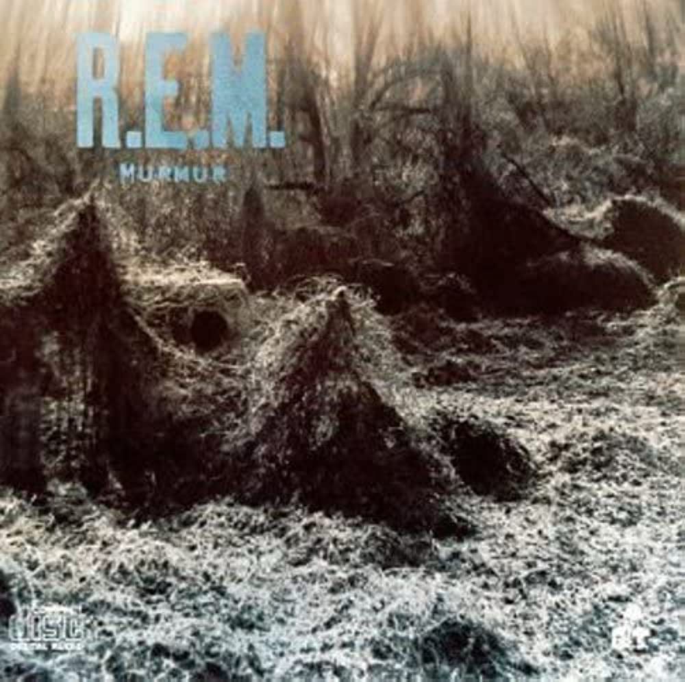 The cover of R.E.M.’s debut album, “Murmer”. The image is of a field with trees at the edge covered in kudzu.
