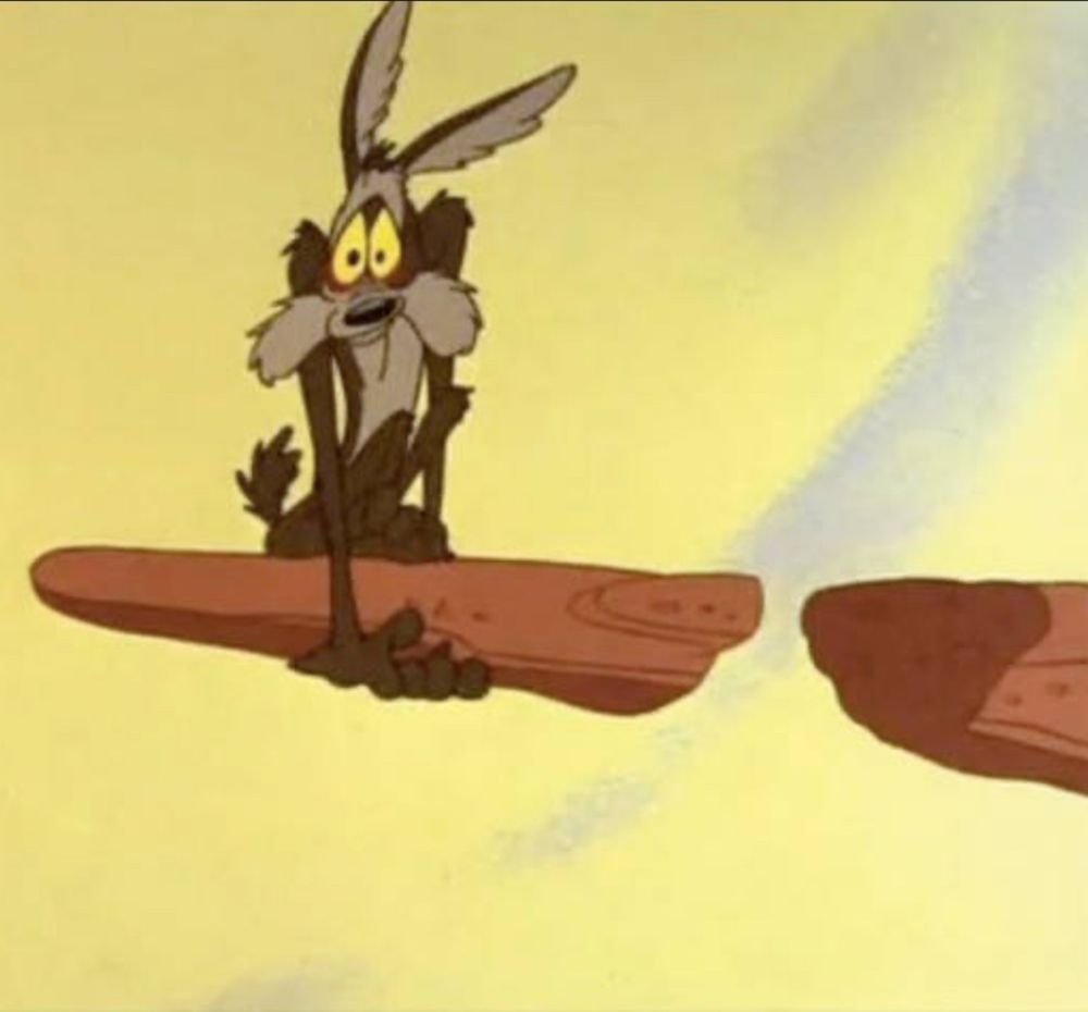 A Wiley Coyote cartoon, of him frightfully clinging to a broken cliff's edge that he broke with his own weight. The moment before a 1000 foot drop.