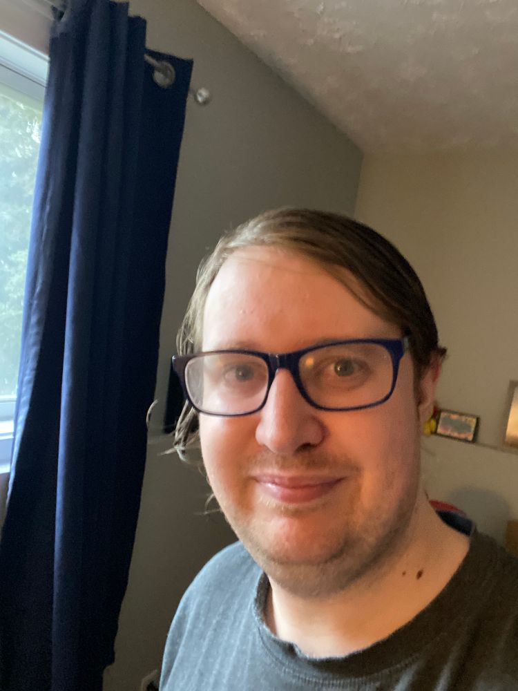 Myself just after I took a shower. I have blue framed glasses, and a black shirt.