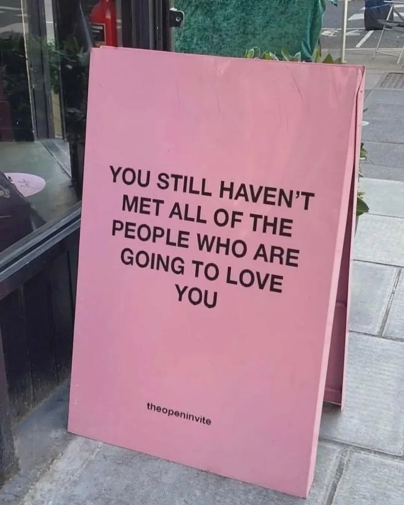 A pink sign that reads "You still haven't met all of the people who are going to love you."