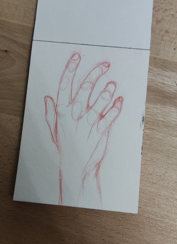A sketch of a human hand in red pencil