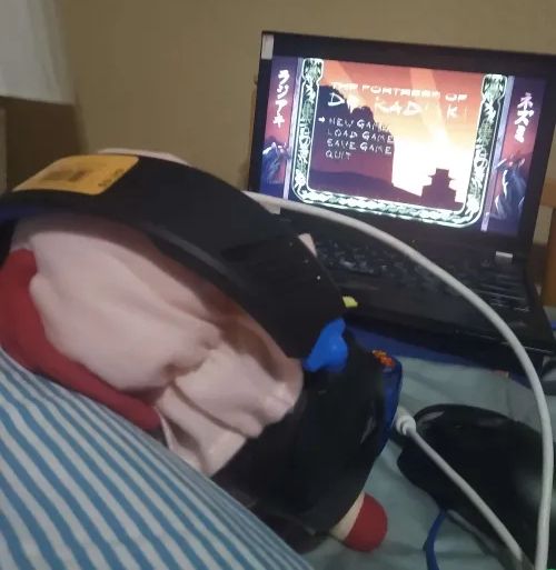 back angle of prior revealing the 2013 era thinkpad she is gaming on playing the zoom platform enhanced edition of Dr. Radiaki.