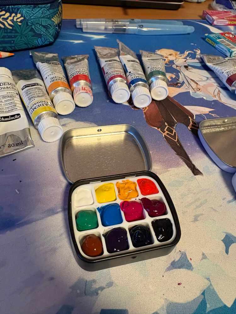 A photo of an altoids pallet box filled with 12 gouache colours. 