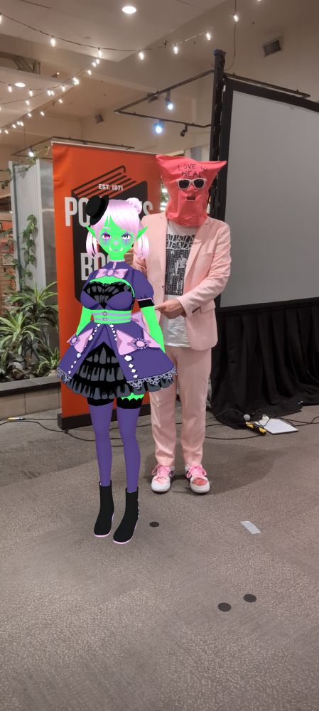 Noiz stands nervously and awkard with legendary author Chuck Tingle at a Powells