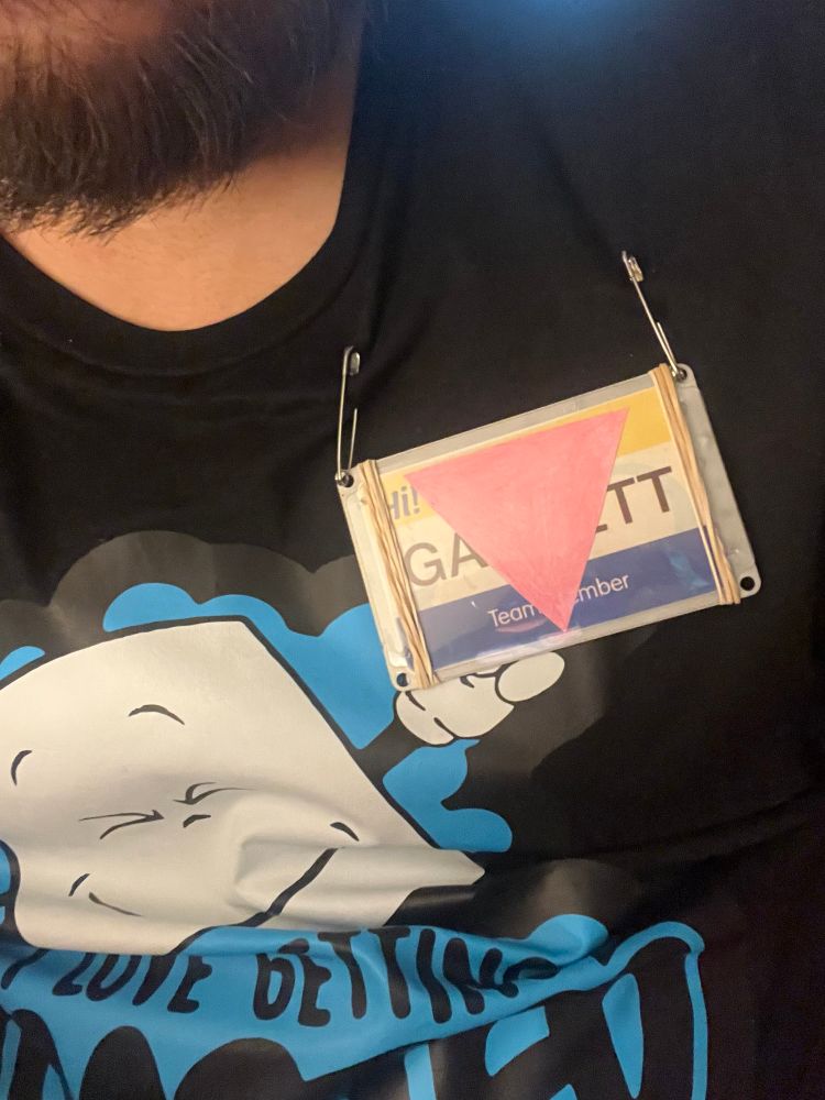 Garrett name tag with the pink triangle identifier, even though I’m technically pansexual.