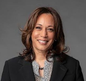 Vice President Kamala Harris smiles in a headshot.