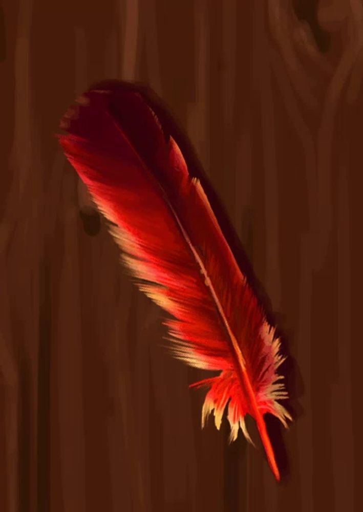 a red feather is on a brown surface