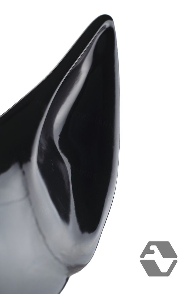 A close up of J9 latex hood's diamond shaped ear in stark contrast against a white backdrop