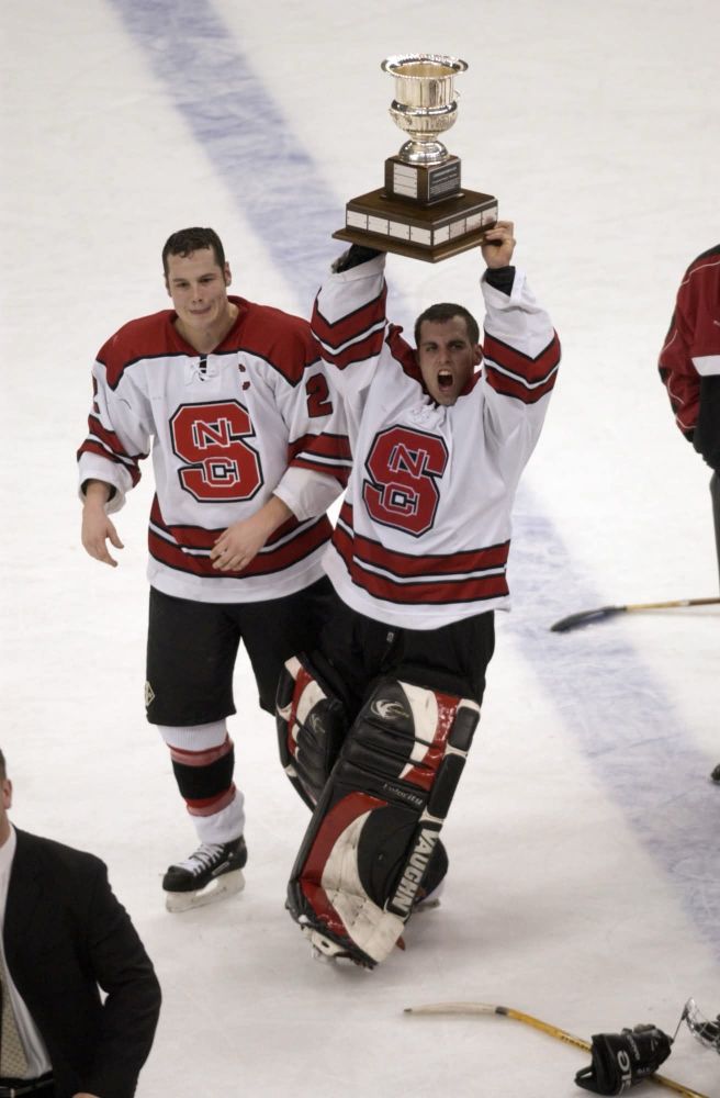 Jorge Alves skates around with the ACC Hockey championship trophy after winning it for NC State University in his goalie pads. 