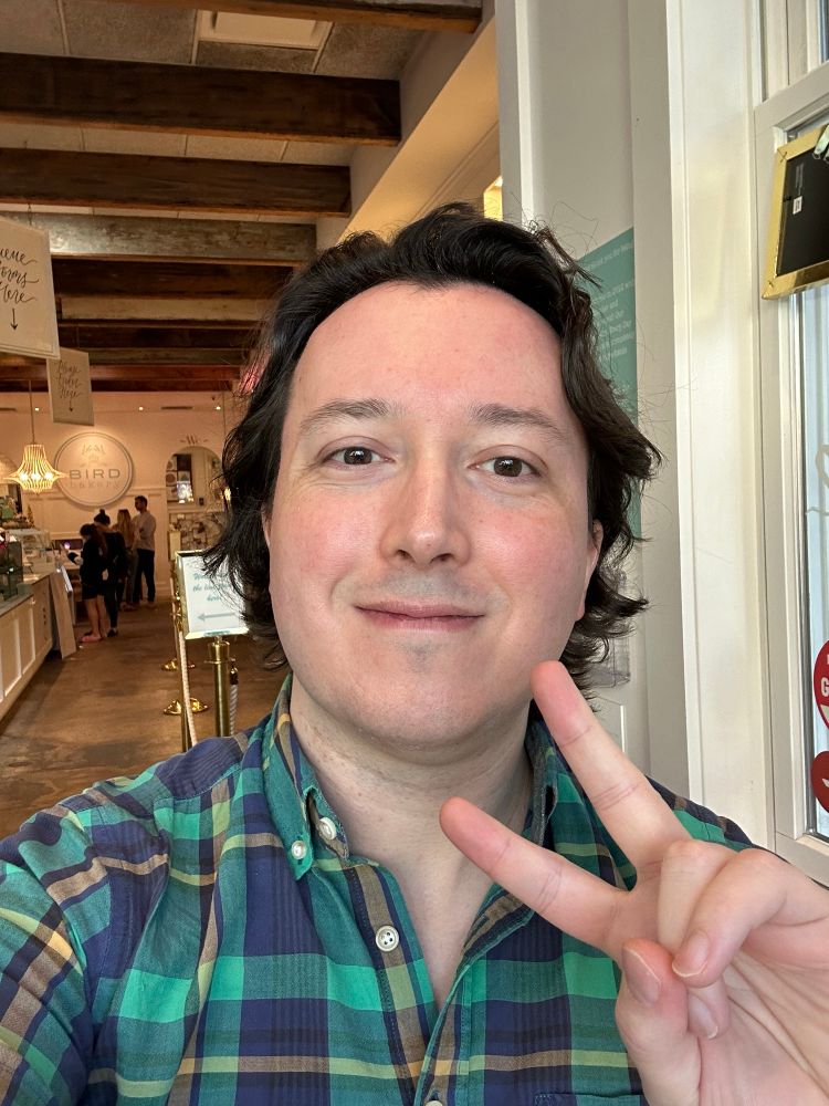 Bobert post haircut giving a peace sign in Bird Bakery