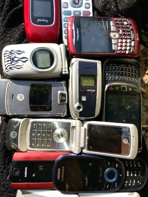 Photo of old cell phones such as flip-phones and blackberry type