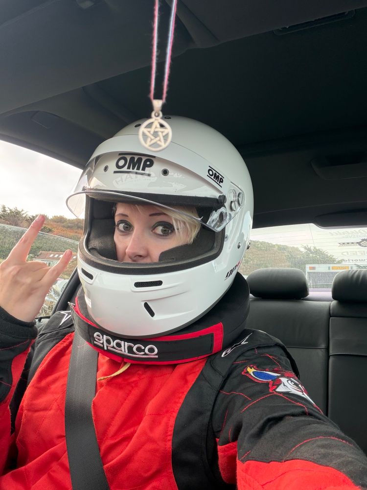 Selfie of Baron in a race suit and helmet. 