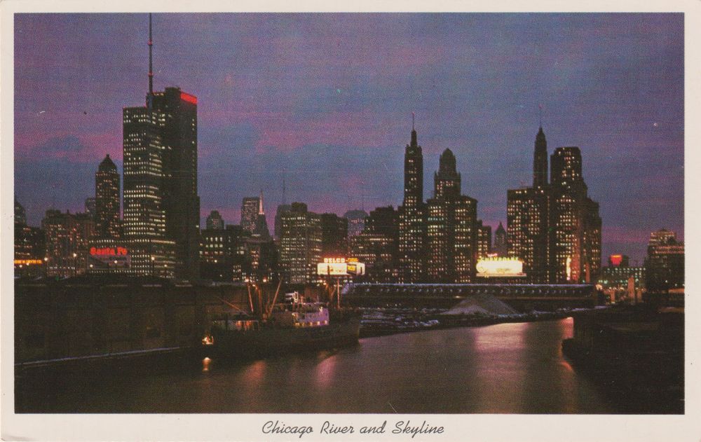 late 1950s color photo postcard of the chicago river at dusk looking southwest with a ship berthed